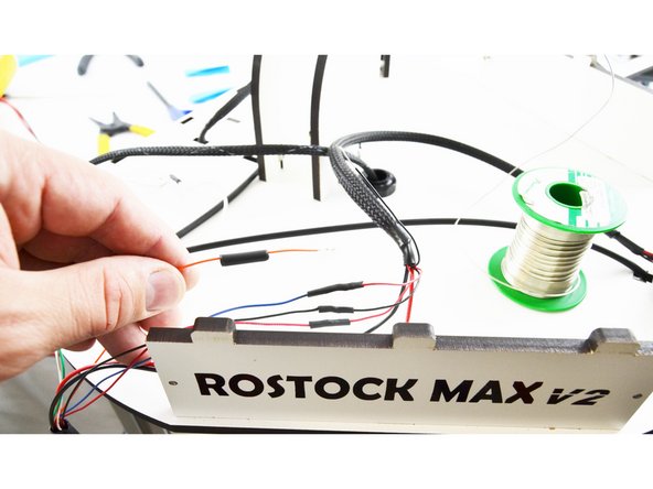 Slide a piece of 15mm long heat-shrink tubing over the orange wire.