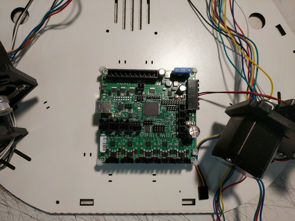 The RAMBo board should be installed in the machine. The board supports will capture the corners of the RAMBo board. You will need to flex the board supports to get them over the corners of the board.