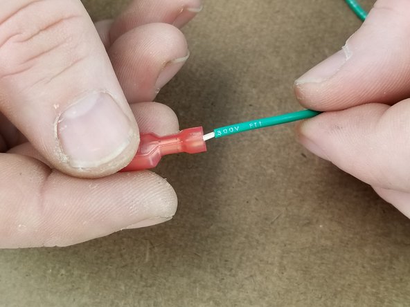 Insert the spade connector on the end of the other short stripped green wire.