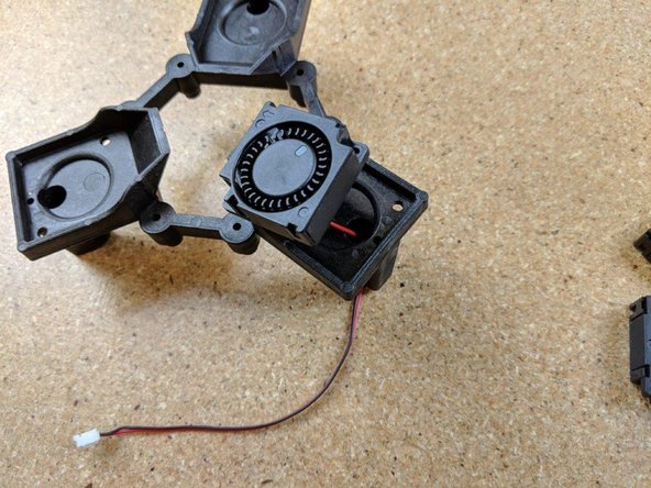 Insert the wire for the fan through the hole in the platform as shown in Pic 1.  There is an arrow on the bottom of the fan showing the direction of airflow, this arrow should be aimed toward the center of the platform.