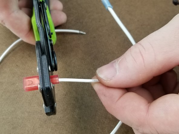 Crimp the spade connector on the end of the short wire as you did with the green wires.