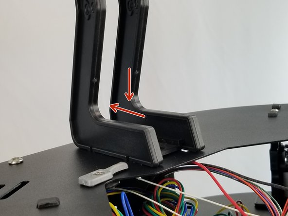 The spool holder will face the outside of the machine having the curved and tall portion of the spool holder on the outside of the machine nearest the extruders as shown in the pictures.