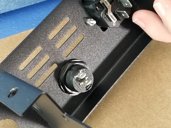 Secure the rocker switch in place with the nut removed at the beginning of this step.  You may need to use a larger set of pliers to tighten the nut securely.