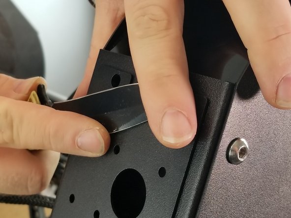 CAREFULLY use a thin object like a screwdriver or pocket knife to pop out all four plastic push rivets that are holding the extruder plate in place.