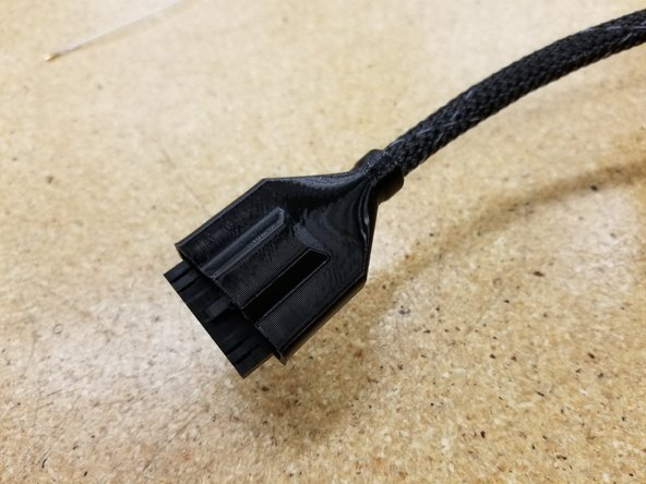 Run everything through the wider cable boot, covering the zip tie and connector.