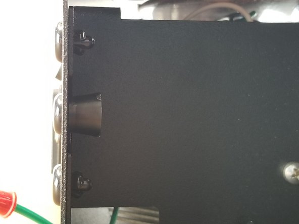 In the middle holes of the sheet metal cover, you will insert the nylon push rivet through the sheet metal and into the panel stop.