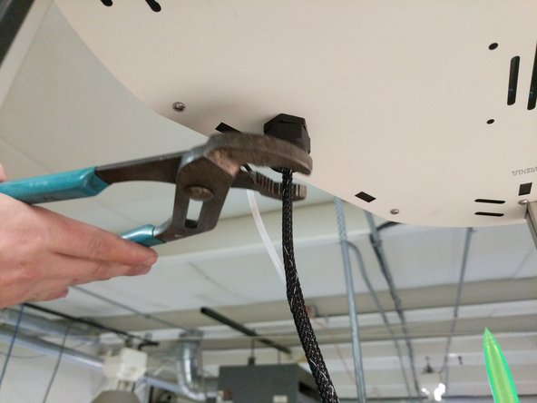 Tighten the strain relief nut on the bottom side of the top assembly