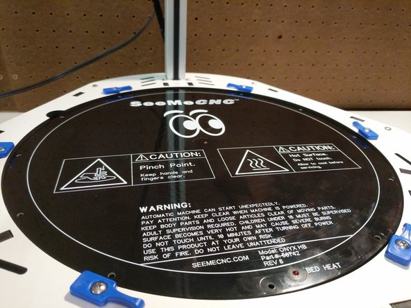 Carefully set the insulator and bed into the base assembly of the printer.