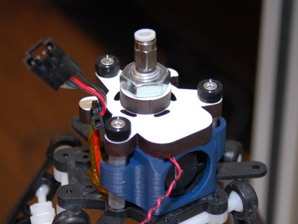 Grab the three thumbscrews you bought and fix the hot end assembly in place.