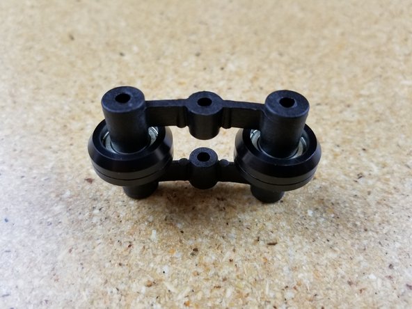 Set two R4 bearings on the inner spring arm as shown in photo #2.