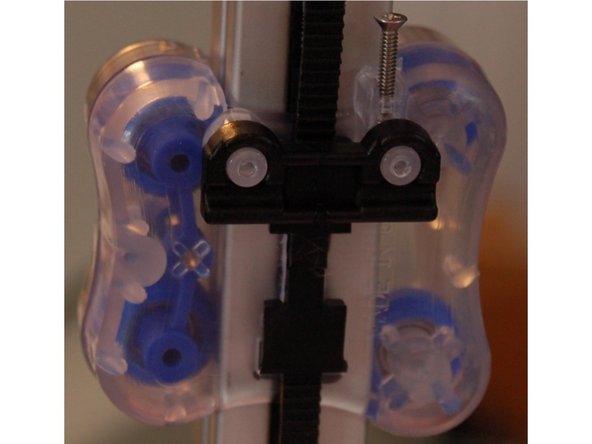 Install an axle support on to the two posts on the face of the carriage as shown in the first photograph.