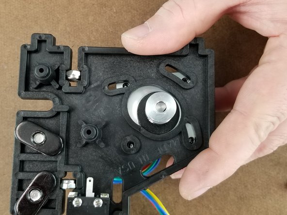 Align the motor with the bracket as shown in Pic 2.  It is easiest to line the screw with the hole that does not have a slot first. In Pic 2 this is in reference to the bottom left hole for the motor mounting hole.