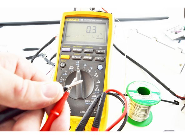 Use your multimeter to determine the polarity of the thermistor leads. You need to label the existing thermistor lead in the top of the printer The same as you labeled it in the bottom of the printer. This lead will eventually be soldered to the GREEN wire from the new hotend whip.