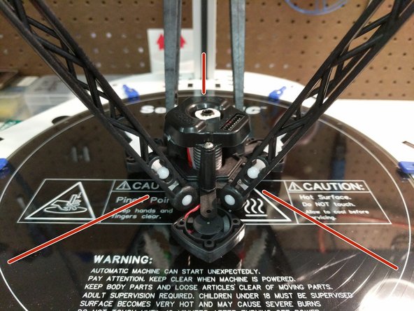 Insert the tensioning spring between the arms in  the slot.