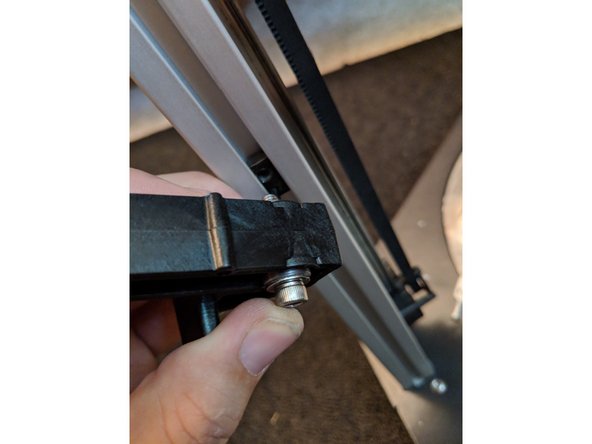 Line the screw up with the threads on the t-nut and tighten the spool hanger to the extusion as shown in Figure 2 and Figure 3.