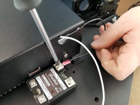 Secure the black wire coming from the hole of the power supply bracket to the screw you just removed as shown in Pic 2.