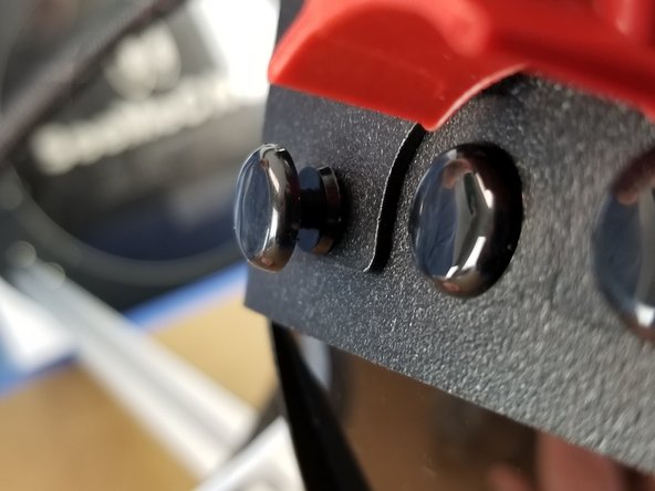 Re-install the plastic rivets by placing them in the mounting holes in the sheet metal, pushing the bottom portion in fully, then pushing the head until the rivet snaps in place flush with the sheet metal.