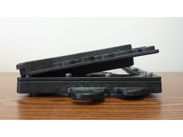 Lay the VAT Top Plate on top of the FEP film.  Insert (2) (12) 6-32 x 5/8&quot; Socket Head Cap Screws into the holes on one of the long edges of the assembly. You will need to tilt the piece in order to get the screws started threading into the Nylon Lock Nuts.