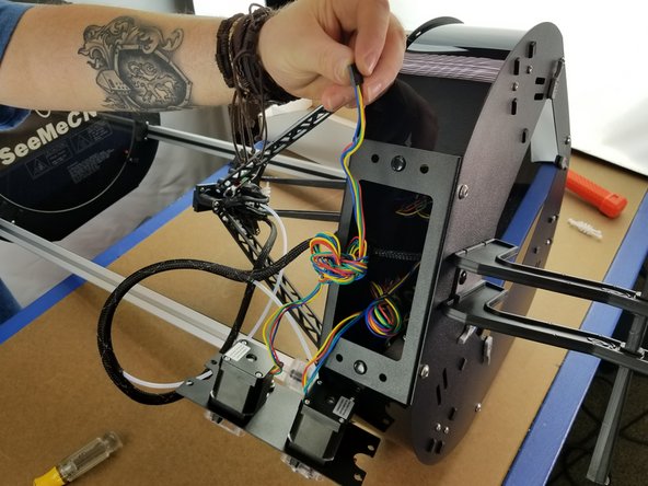 Pull some length out of the bundle of wires coming from the extruder motor.