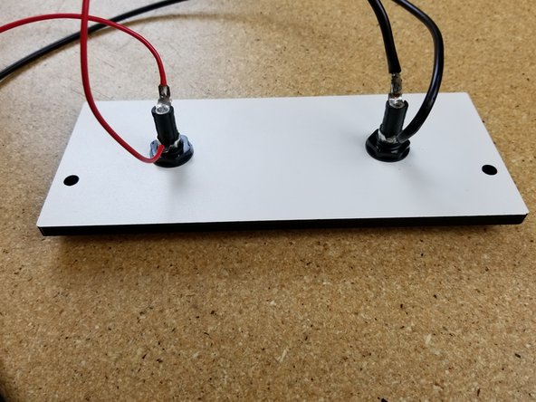 Solder the 20awg red wire from the hotend and the extra short length of 18awg  red wire in your kit to the HOT END 5A fuse holder location, indicated by the COMIC SANS laser etched into the wood.