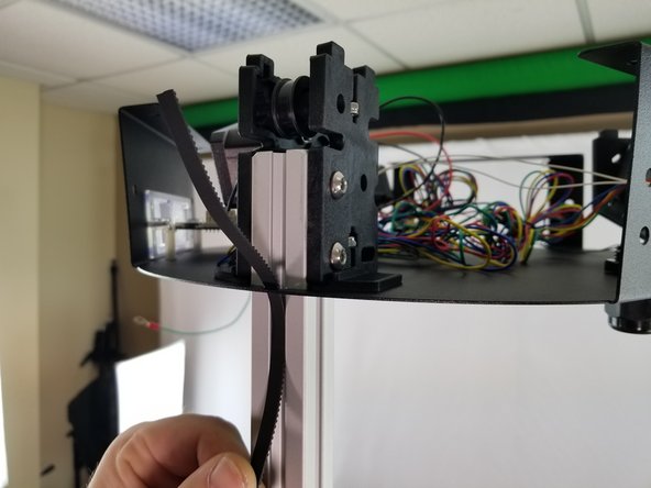 Route the belt up the extrusion to the top following the channel in the extrusion.  Make sure to route the belt inside the sheet metal frame as shown in Pic 1.