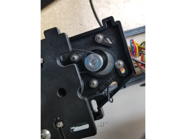 Tension the belts by rotating the motors  to pull the belt tighter. While holding the motor in place, tighten the motor screws so the belt tension is locked in to place.