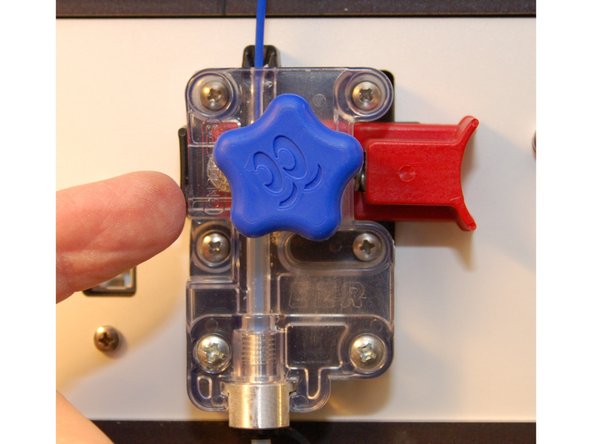 Once the new filament has reached the hot end, turn the manual feed knob clockwise in order to purge out the previous material.  Do this until you see the pure color of the new filament.