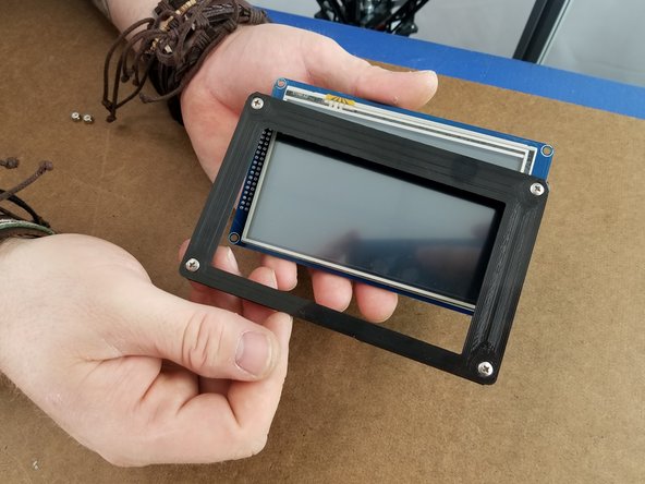 Place the Touch Screen Frame over the touch screen with the notch in the frame matching up with the SD card reader at the bottom of the screen.