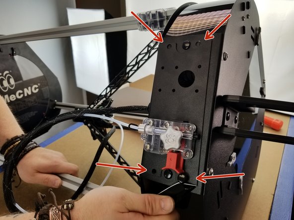 CAREFULLY use a thin object like a screwdriver or pocket knife to pop out all four plastic push rivets that are holding the extruder plate in place.
