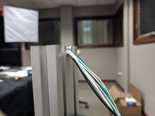 There are reliefs in the T-Slot for the wires so they do not get pinched between the towers and the aluminum plate. On the bottom of the machine only the Z tower has wires exiting the tower.