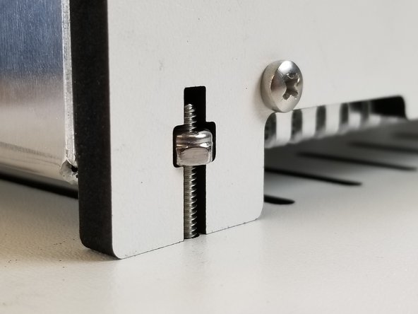 The blocker panels will slide down into rectangular cuts in the base panel and then the whole assembly will slide and lock into place. You should then secure it with the (2) screws referenced above.