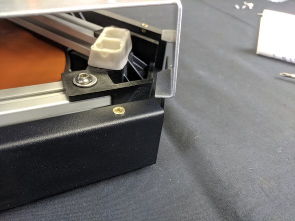 To remove the cover, lift it straight up on all three corners. You will then need to gently pull out on the silver sides (one corner at a time) to un-hook the cover.