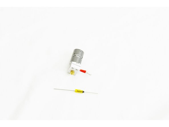 Slide the thermal safety fuse into the side of the heat sink with the black epoxy coated end being on the same side as the leads for the heater cartridge.