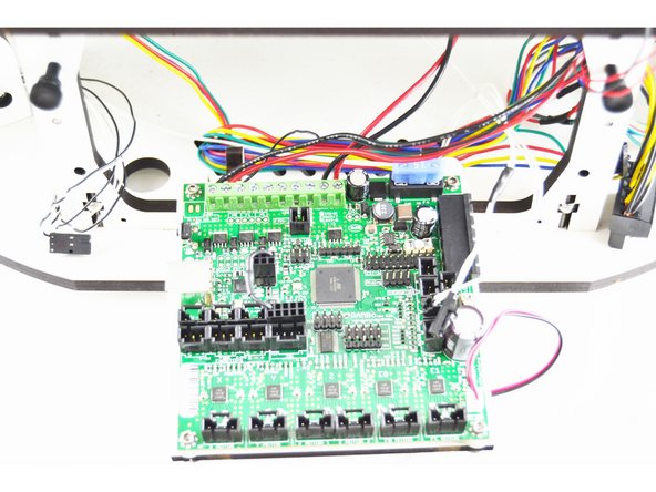 Plug the thermistor wires back into the RAMBo board in the T0 location. This connection is keyed. (shown in the image with a blue arrow)