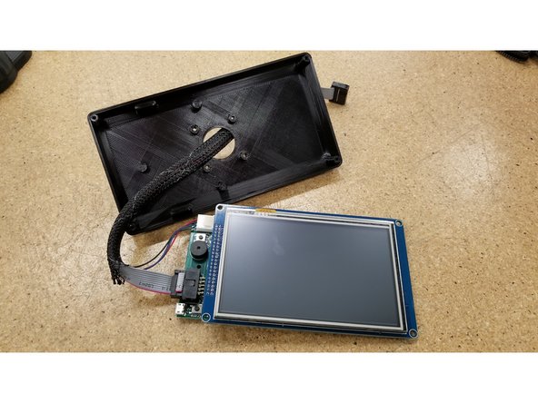 Pass the cables through the hole in the back of the enclosure, and insert the screen as shown.