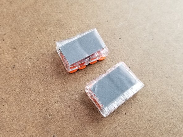 They will have double sided tape pre-installed on them.  You will remove the red protective film from the tape to expose the adhesive as shown in Pic 2.