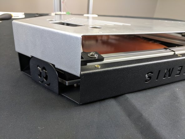 To remove the cover, lift it straight up on all three corners. You will then need to gently pull out on the silver sides (one corner at a time) to un-hook the cover.