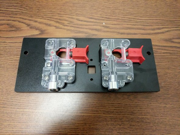 Install the extruder motor assemblies on the extruder plate. Fasten using (2) 6-32 machine screws and nylon lock-nuts for each extruder.