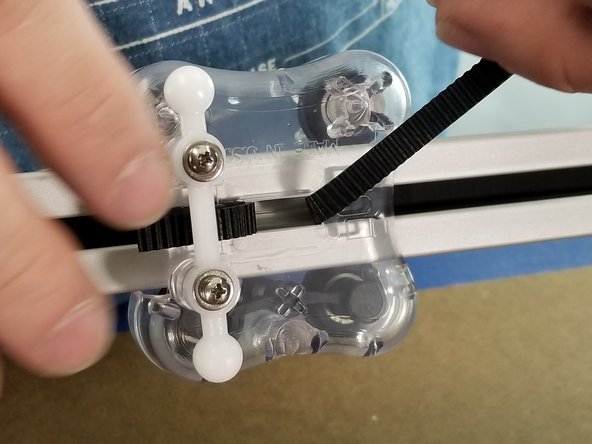 Repeat the process with the belt coming from the bottom of the machine coming up the extrusion, behind the carriage and use a tool to bring the belt out of the carriage as shown in Pic 2.