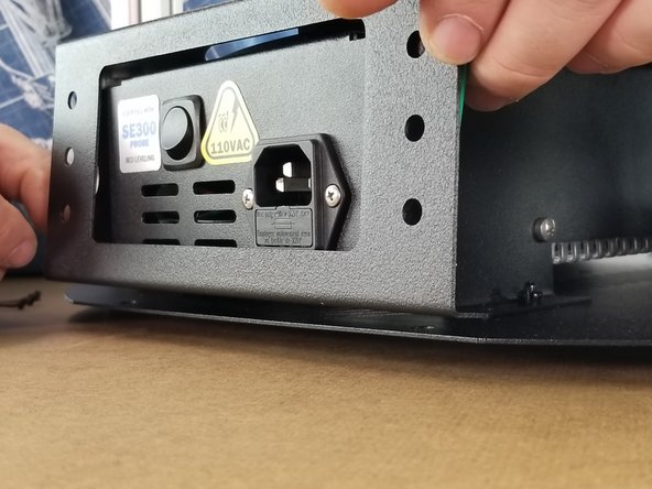 Slide the lower sheet metal cover down and over the power supply bracket.