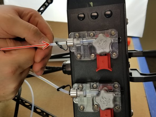 Press the PTFE tube into the EZR after locking the PTC fitting with the lanyard to ensure it is fully seated and locked in place.