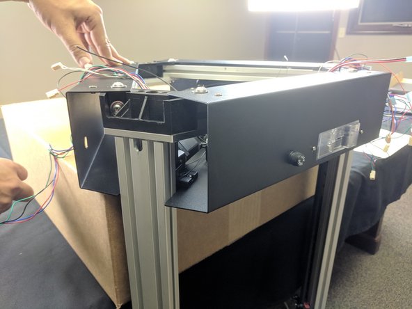 As you did before, grasp all the wires at the top of the tower (the end with the stepper motor) fold them into the relief in the T-Slot and hold to give them some memory.