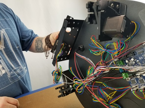 On the machine feed the wires into the large opening on the upper frame and align the extruder plate to the opening and holes.