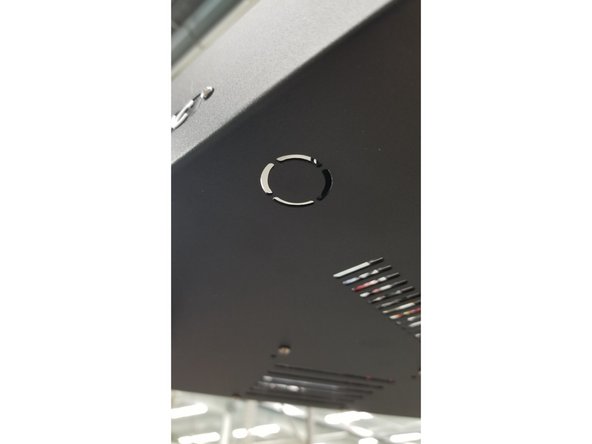 Snip the for tabs on the mounting post hole at the bottom of the top machine assembly using sharp, strong snippers.