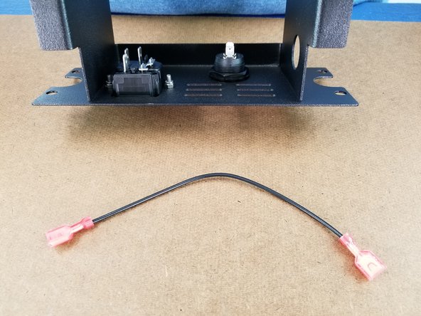 This step you will use the power supply bracket and the black wire with a spade connector at each end of it.