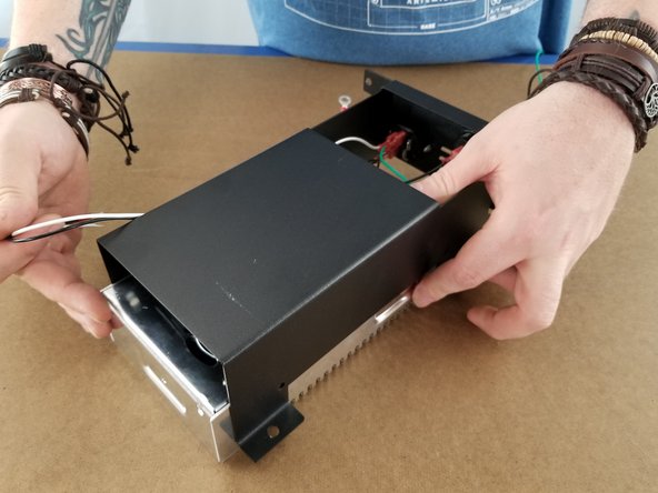 Slide the power supply bracket over the power supply shown in Pic 2.