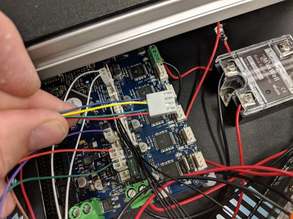 The extruder motor connector (4-pin red, green, yellow, blue wires, exiting the X tower wire bundle) is keyed and will only connect in one direction in the &quot;E0&quot; location indicated in the photo.