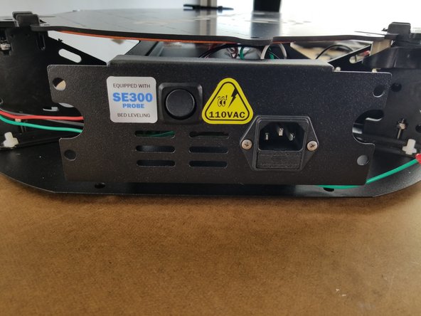 The sticker is a notice to not work on the machine while plugged in due to the AC voltage going through the wires behind the bracket as a safety precaution.