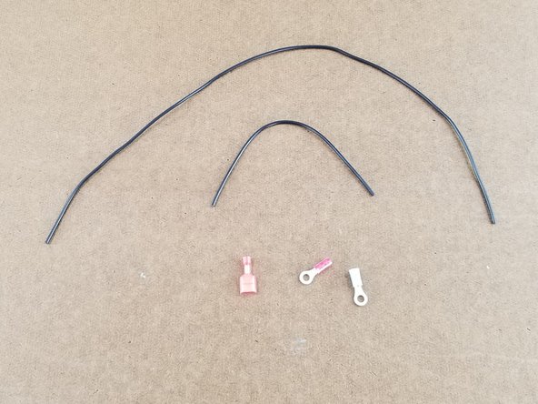 This step will use 2 black wires. One short and one long. Note that there are 2 other very long black wires, these will not be used yet. Also you will use one blue ring terminal, one small red ring terminal, and one spade connector.
