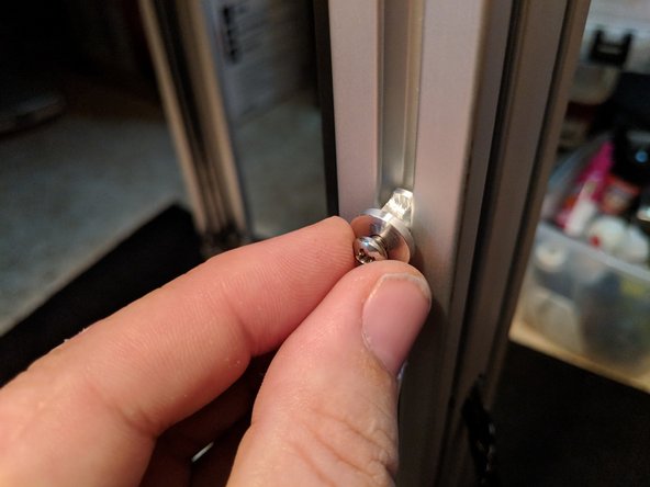 Approximately 2.5&quot; above the hole, Insert one of the two extruder hangers on the left side of the rail when viewing it from the outside as shown in Figure 1.